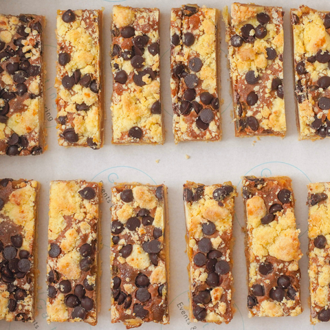 Row of chocolate chip cookie bars on a white surface