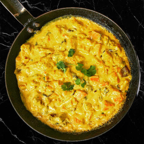 Fried omelette with vegetables in a pan on a black background
