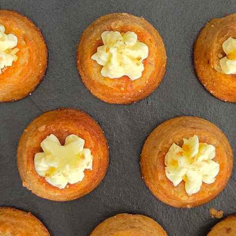 Small round pastries with a cream filling on a dark surface