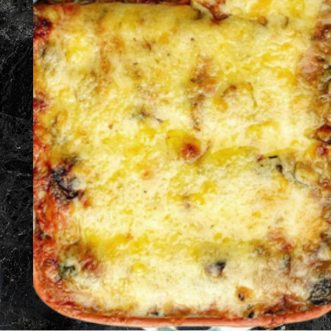 Cheesy baked dish on a black surface